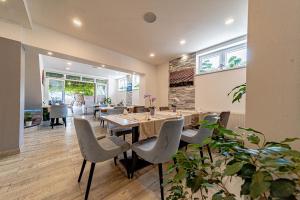 a dining room with a table and chairs at Bed & Breakfast Villa Vrgorac in Orebić