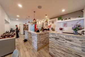 a man standing at a bar in a restaurant at Bed & Breakfast Villa Vrgorac in Orebić