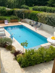 a swimming pool in a yard with at Chambre Chic et Charme dans Moulin-Piscine in Rouessé-Vassé