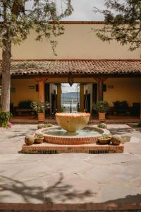a large fountain in the middle of a courtyard at Tapalpa Country Club Hotel in Tapalpa