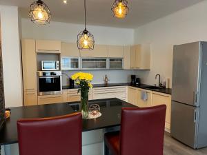 a kitchen with a vase of flowers on a table at Rohrbacher Herz in Rohrbach in Oberösterreich
