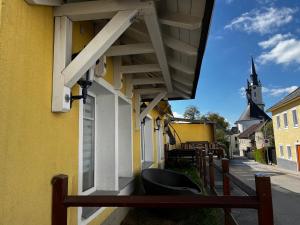 a building with a bench next to a church at Rohrbacher Herz in Rohrbach in Oberösterreich