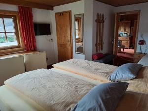 a bedroom with two beds and a window at Seilhof in Ennsling