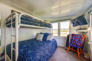 une chambre avec un lit superposé et une chaise dans l'établissement Deck with Views Lakeside Spring Lake Cottage, à Spring Lake