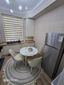 a kitchen with a table and a refrigerator at Golden house deluxe in Bukhara +11 photos