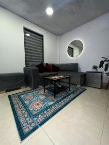 a living room with a couch and a table on a rug at Guatavita Loft - Apartamento in Guatavita