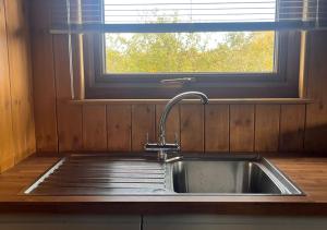 a sink in a kitchen with a window at The Apple Rest in Snitterfield +7 photos