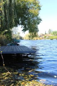 un muelle en medio de una masa de agua en Luxus Vendégház a Szigetköz szívében, en Dunasziget 54 fotos más