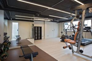 a gym with treadmills and machines in a room at BCN MONTJUÏC Apartments in Barcelona