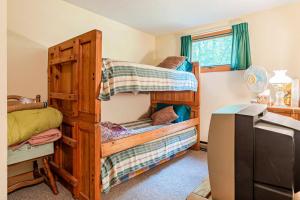 a bedroom with two bunk beds and a desk at Moose’in Around in Sweden