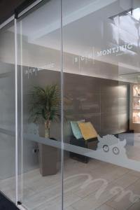 a glass window with a table and a potted plant at BCN MONTJUÏC Apartments in Barcelona +30 photos