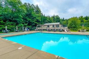 a large blue swimming pool in front of a house at Moose’in Around in Sweden