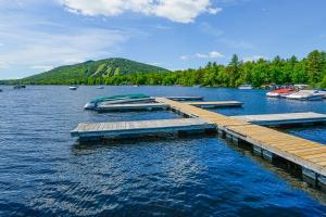 a dock on a lake with boats in the water at Moose’in Around in Sweden