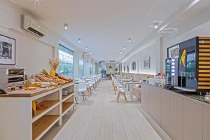 a restaurant with a long corridor with tables and chairs at BCN MONTJUÏC Apartments in Barcelona