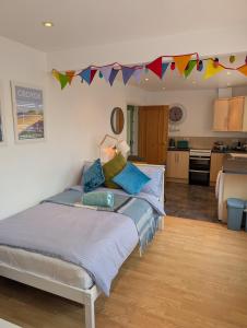 a bedroom with a large bed with flags on the wall at The Nook in Barnstaple
