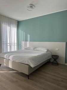 a bedroom with a bed and a large window at OFF 32 Suites in Melzo