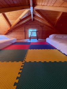 a room with two beds on a colorful rug in a attic at Mammoth Cave Accommodation for a Kentucky Glamping Experience in Mammoth Cave