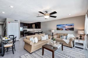 a living room with a couch and a ceiling fan at Commodore's Retreat 305 in Seagrove Beach