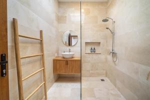 a bathroom with a sink and a shower at Cassandra Villa 1 - Family Paradise in Sanur +17 photos