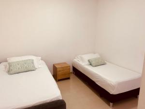 a room with two beds and a night stand at VILLA CRISTAL in Santa Helena