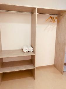 a walk in closet with wooden shelves and shoes at VILLA CRISTAL in Santa Helena