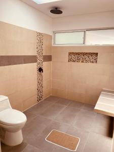a bathroom with a toilet and a shower at VILLA CRISTAL in Santa Helena +110 photos