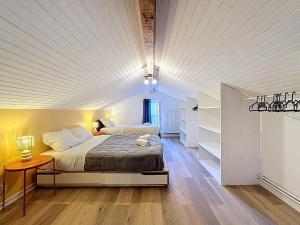 a bedroom with a bed with a white ceiling at Maison 7 personnes Quartier Oradou Pardieu in Clermont-Ferrand