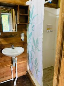 a bathroom with a sink and a shower curtain at Majagua in Bahía Solano +88 photos