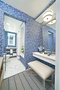 a bathroom with blue walls and a mirror at Peabody Memphis in Memphis