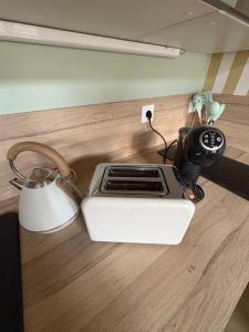 a toaster sitting on a counter next to a camera at Cozy House in Yvetot +5 photos