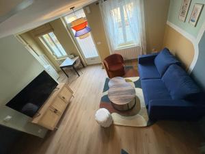 a living room with a blue couch and a table at Cozy House in Yvetot