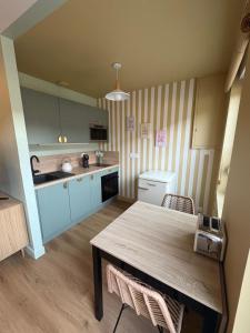 a kitchen with a table and a counter top at Cozy House in Yvetot