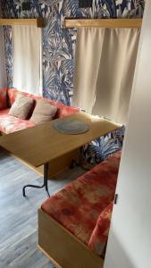 a living room with a couch and a table at L'Ardres de paix in Ardres