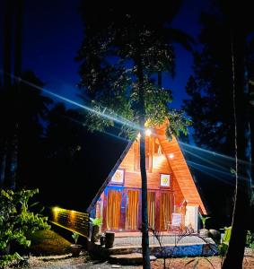a tree house with a light on it at night at Siri Villa Cabana Habaraduwa in Habaraduwa