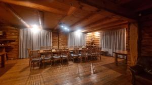 a dining room with a table and chairs in a cabin at Inčukalna Strops in Inčukalns