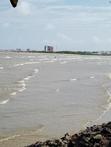 a beach with a kite flying over the water at Lar caprichoso in Aracaju