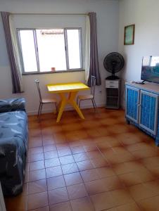 a living room with a yellow table and chairs at Lar caprichoso in Aracaju
