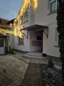 a building with an awning on the side of it at Prenociste Aurelia in Subotica