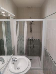 a bathroom with a sink and a shower at Médis Royan Saujon in Médis