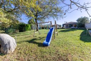a playground with a blue slide in a yard at Villa Mainenti in Višnjan