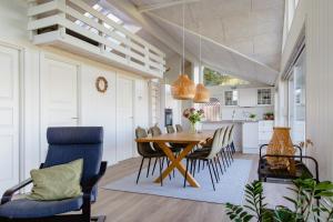 a kitchen and dining room with a table and chairs at Fresh Air On Open Terrace With View in Hejls