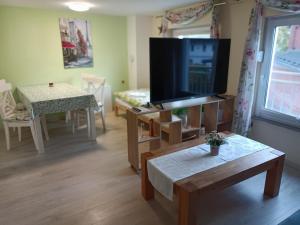 a living room with a large flat screen tv at NEU! Ferienwohnung Storchennest OG in Pömmelte