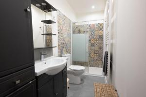 a bathroom with a sink and a toilet and a shower at Bardelours 2 Charming apartment with terrace in the heart of the villag in Saint-Bauzille-de-Montmel
