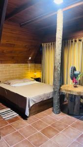 a large bed in a room with a tree at Siri Villa Cabana Habaraduwa in Habaraduwa