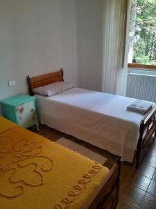 a bedroom with two beds and a window at Barino Pietragavina  +13 photos