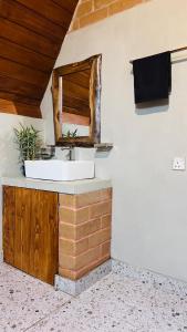 a bathroom with a sink and a mirror at Siri Villa Cabana Habaraduwa in Habaraduwa +44 photos