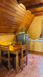 a kitchen with a wooden table and chairs in a room at Siri Villa Cabana Habaraduwa in Habaraduwa
