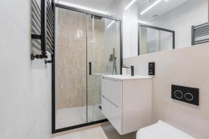 a bathroom with a shower and a sink and a toilet at K26UrbanNest in Wrocław +19 photos