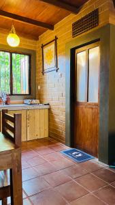 a kitchen with a door and a tile floor at Siri Villa Cabana Habaraduwa in Habaraduwa