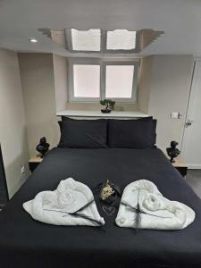 a bedroom with a bed with two towels on it at Aphrodite House in Guebwiller